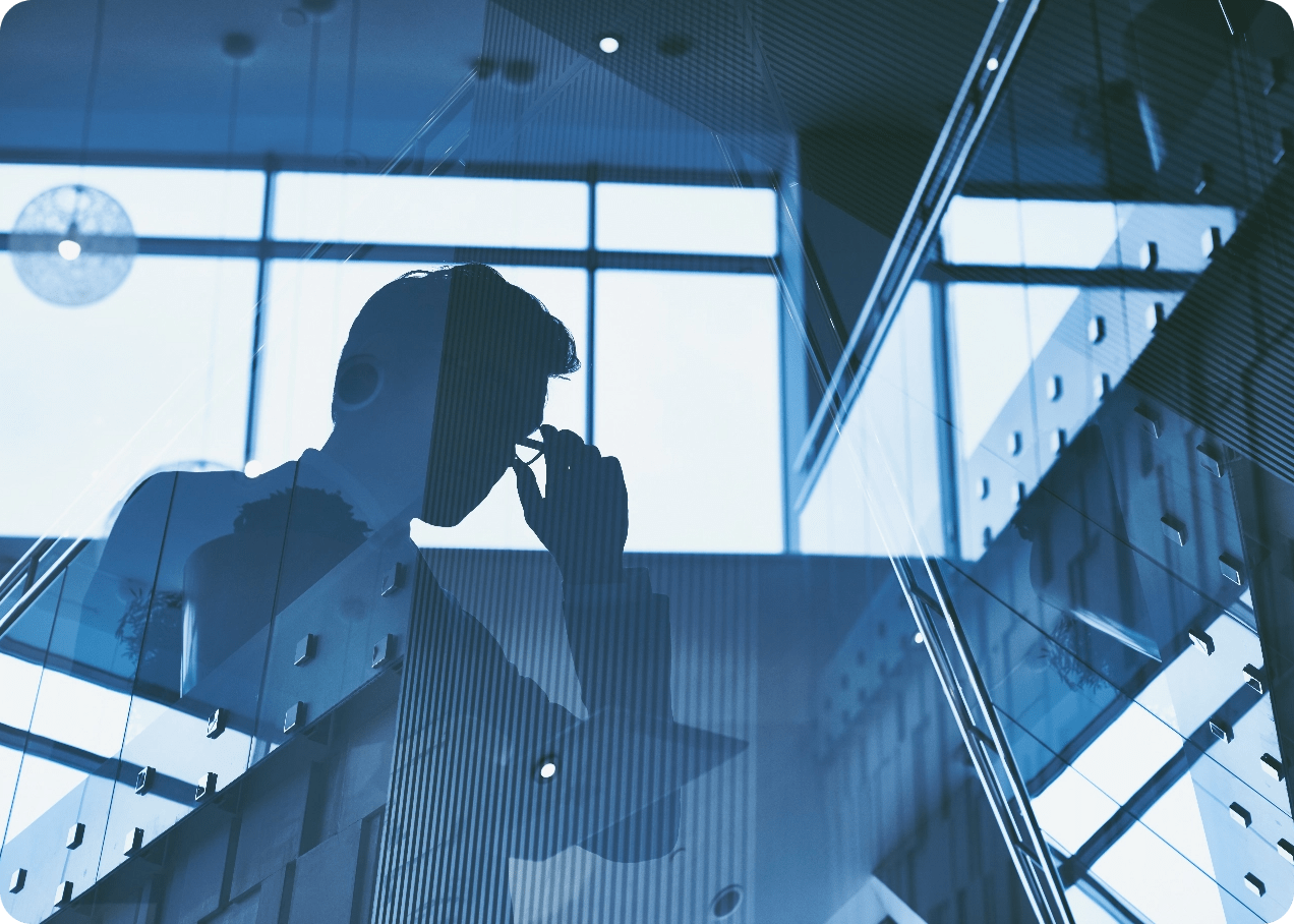 Glass reflection of a business man adjusting his glasses